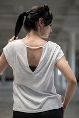 Woman wearing organic cotton and bamboo tee with deep V open keyhole back