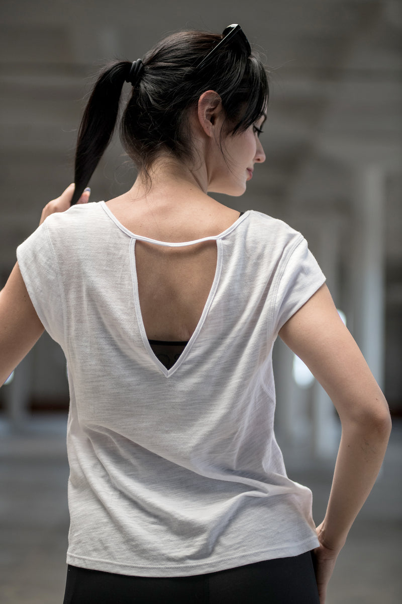 Woman wearing organic cotton and bamboo tee with deep V open keyhole back
